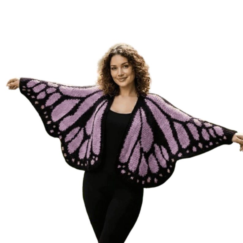 May include: A knitted butterfly wing-shaped cardigan in black and lavender. The open-front sweater features a detailed wing pattern, with a solid black border and lavender interior. The sleeves extend to the elbows, creating a dramatic, whimsical look.