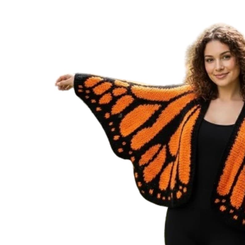 May include: A knitted butterfly wing shawl in orange and black. The shawl is designed to resemble a monarch butterfly wing, with intricate patterns and a textured appearance. The wings are worn over the shoulders.