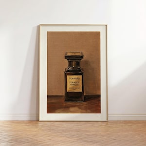 May include: Framed print of a Tom Ford Tobacco Vanille perfume bottle. The dark brown bottle has a rectangular shape with a black cap. The label reads "Tom Ford Tobacco Vanille Eau de Parfum 50ml". The background is a warm brown color.