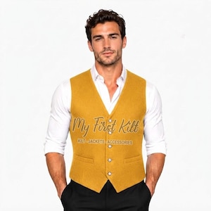 May include: A mustard yellow wool-textured waistcoat featuring a V-neckline, five silver-toned buttons, and two front pockets. The waistcoat is worn over a crisp white long-sleeved button-down shirt. The text My First Kilt KILT-JACKETS-ACCESSORIES is visible.