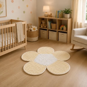 May include: A flower-shaped area rug featuring a central white circular section surrounded by five rounded, light yellow petals. The rug is crafted from a thick, textured yarn material, creating a soft and plush appearance on the floor.