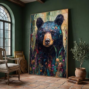 May include: Large framed oil painting of a black bear with a golden-brown snout. The bear is surrounded by colourful wildflowers and green foliage. The artwork has a textured, impressionistic style, with visible brushstrokes. The painting is displayed in a room with a green wall.