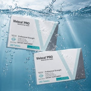 May include: Two white boxes of Viviscal PRO dietary supplements for advanced hair health are submerged in water. Each box features the text "Professional Strength" and "180 Tablets". The boxes are white with blue and gray accents.