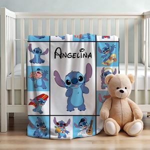 May include: A personalized baby blanket featuring the character Stitch from Lilo & Stitch. The blanket has a white background with blue squares and images of Stitch. The name "Angelina" is printed on the blanket. A stuffed teddy bear is next to the blanket.