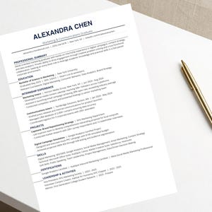 May include: A resume titled "ALEXANDRA CHEN" with Marketing & Communications Graduate at the top. A gold pen rests on the white paper. The resume includes sections for Professional Summary, Education, Internship Experience, Projects, Skills, Certifications, and Leadership & Activities.