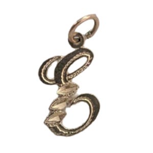 May include: A gold-toned pendant in the shape of the letter "e". The pendant has a loop at the top for hanging. The letter is outlined in a dark color and embellished with small, clear stones.