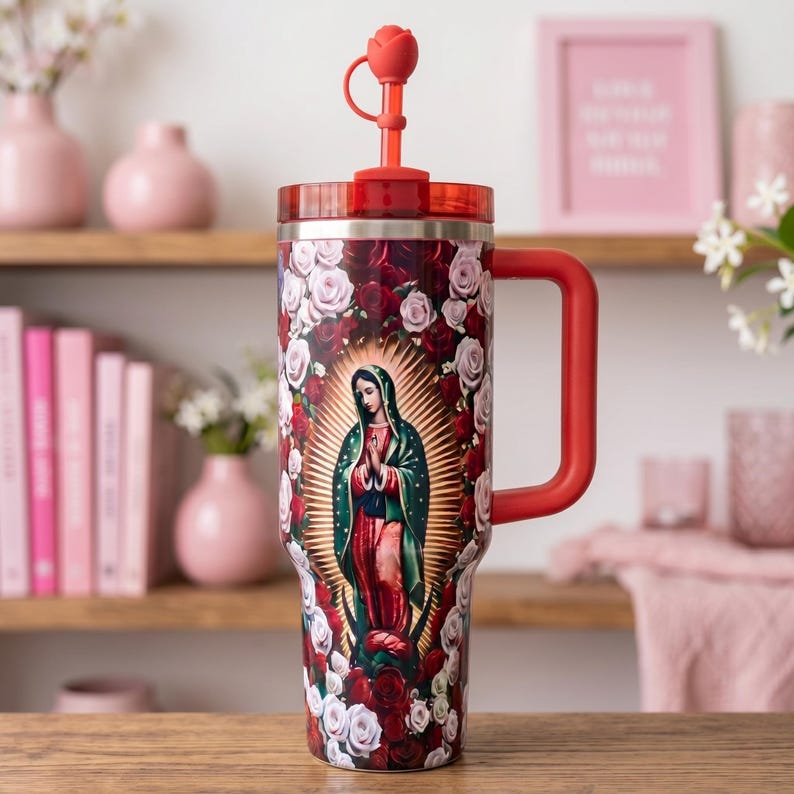 May include: A large red and stainless steel tumbler featuring an image of Our Lady of Guadalupe surrounded by red and white roses. The tumbler has a red handle, a red lid, and a red straw with a rose-shaped topper.