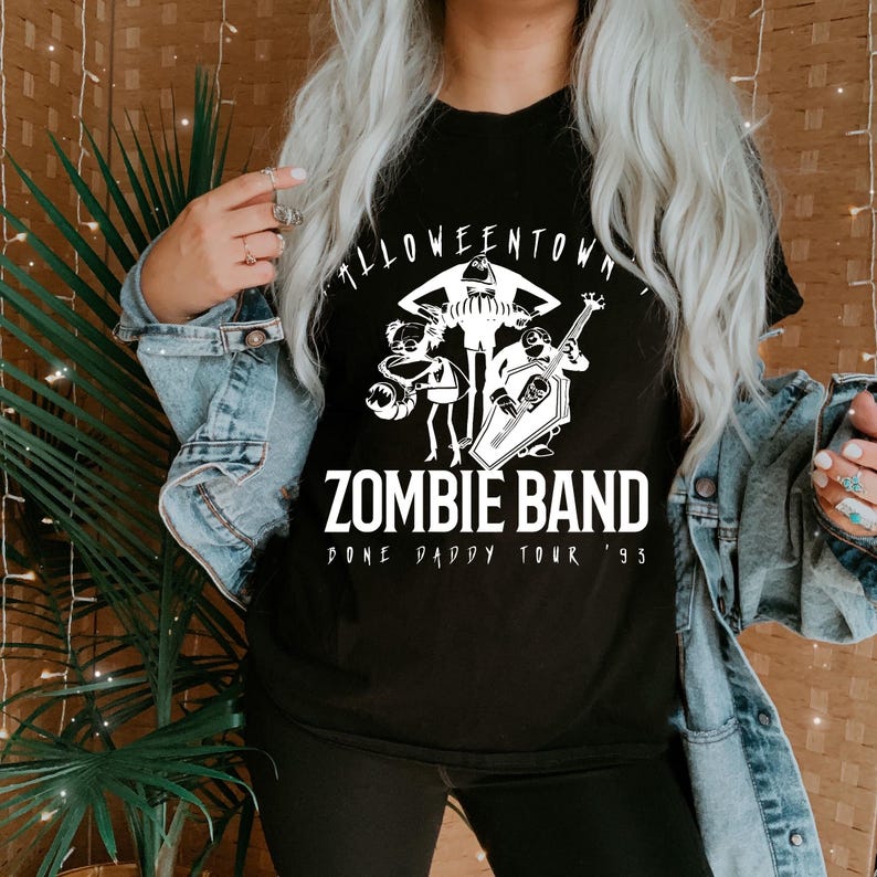 May include: Black t-shirt with a white graphic of a band of zombies. The text "Halloweentown Zombie Band" is above the graphic, and "Done Daddy Tour '93" is below. The shirt is a crew neck.