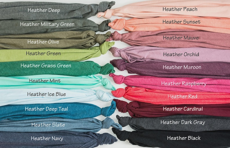 May include: A collection of folded fabric samples in various colors, including heather deep, military green, olive, green, grass green, mint, ice blue, deep teal, slate, and navy. Each sample is labeled with its color name.