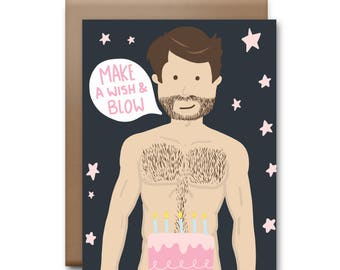 May include: A birthday card with a cartoon illustration of a man with a beard and a cake with candles. The text on the card says "Make a wish & blow".
