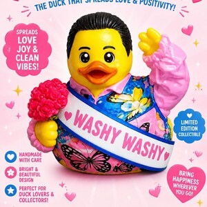 May include: A yellow rubber duck collectible with black hair, wearing a blue and pink floral vest with ruffled sleeves. It holds a pink flower bouquet and wears a white sash labeled WASHY WASHY. The background features pink text and hearts.