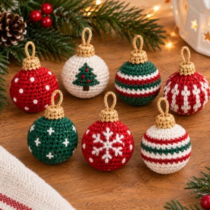 May include: A set of seven round, crocheted Christmas ornaments featuring various designs including white polka dots, a green pine tree, red and green stripes, white crosses, and a white snowflake, each topped with a gold crocheted loop.