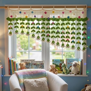 May include: A crocheted window valance with a floral design. The valance is cream-colored with green leaves and colorful flowers. The window is decorated with books, stuffed animals, and a blanket.