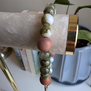 Handcrafted beaded cross charm braclet tied with elastic string