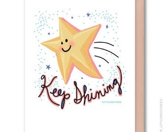 May include: A yellow star with a smiling face and a blue trail behind it. The text "Keep Shining" is written in black cursive below the star. The background is white with blue dots.