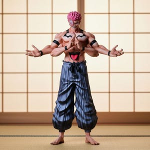Puede incluir: Figura detallada de un personaje con pelo rosa puntiagudo, múltiples brazos y una expresión amenazante. La figura está sin camisa, con pantalones azul oscuro y brazaletes negros. La figura posa con las manos abiertas, sobre un fondo tradicional japonés.
