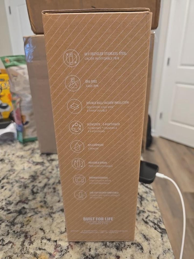 May include: A cardboard box with text and icons, including "18/8 Recycled Stainless Steel", "BPA Free", and "Double Wall Vacuum Insulation". The box has a diagonal striped pattern and the words "Built for Life" at the bottom.