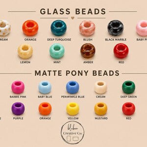 May include: A collection of glass beads and matte pony beads arranged in rows with labels. Glass beads include cream, orange, deep turquoise, blush, black marble, baby pink, lemon, mint, amber, and red. Matte pony beads include pinks, blues, greens, and more.