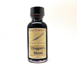 May include: A small glass bottle filled with a dark red liquid, featuring a black screw-top cap and a beige rectangular label. The label displays the text Ceridwen's Scribe Supplies, Dragon's Blood, 1 fl oz, external use only, and a feather quill.