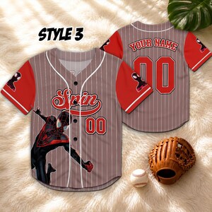 May include: A baseball jersey with a brown and white pinstripe design, featuring red sleeves and accents. The jersey has the word "Spin" and the number "00" on the front, and the words "Your Name" and the number "00" on the back. A baseball glove and ball are also in the image.