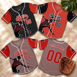 May include: Four baseball jerseys featuring the word "Spin" and the number "00". The jerseys are black, red, and brown with a Spider-Man graphic. A baseball glove is also visible.