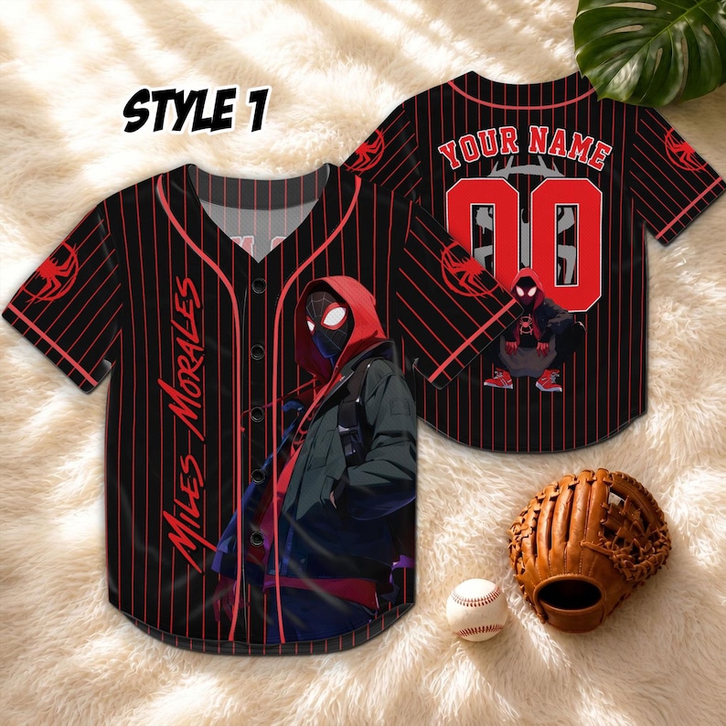 May include: Black and red baseball jersey with pinstripes, featuring a graphic of a superhero. The jersey has the text "MILES MORALES" on the front and "YOUR NAME" with a number on the back. A baseball, glove, and the text "STYLE 1" are also visible.