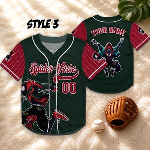 May include: A dark green baseball jersey with red pinstriped sleeves, featuring the text Spider-Verse and the number 00 on the front. The back displays the text Your Name above a graphic of a character in a red and black suit. Includes a baseball glove.