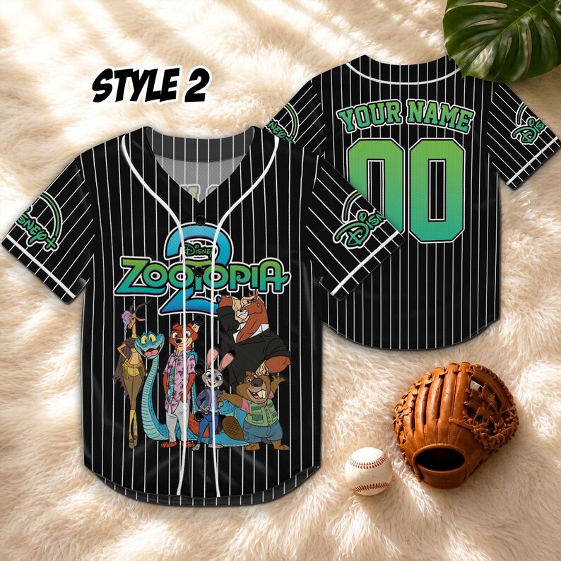 May include: Black and white pinstripe baseball jersey with "Zootopia" graphic and "Style 2" text. The jersey features a Disney logo and a green and white number 00 on the back. A baseball glove and ball are in the foreground.