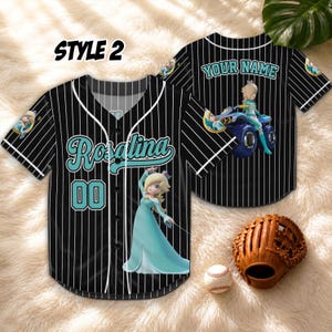 May include: Black and white pinstripe baseball jersey with the name "Rosalina" in teal script and the number "00". The jersey features a cartoon character in a teal dress. The words "YOUR NAME" are on the back of the jersey. A baseball and glove are in the image.