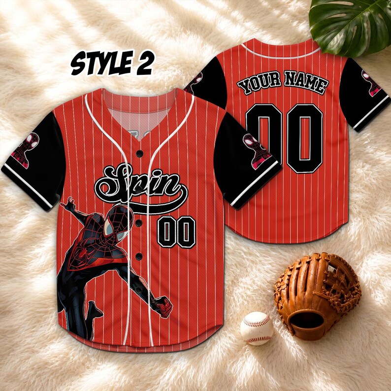 May include: Red and white pinstripe baseball jersey with black sleeves. The jersey features a Spider-Man graphic, the word "Spin", and the number "00". The back of the jersey has the text "YOUR NAME" above the number "00". A baseball glove and ball are also in the image.
