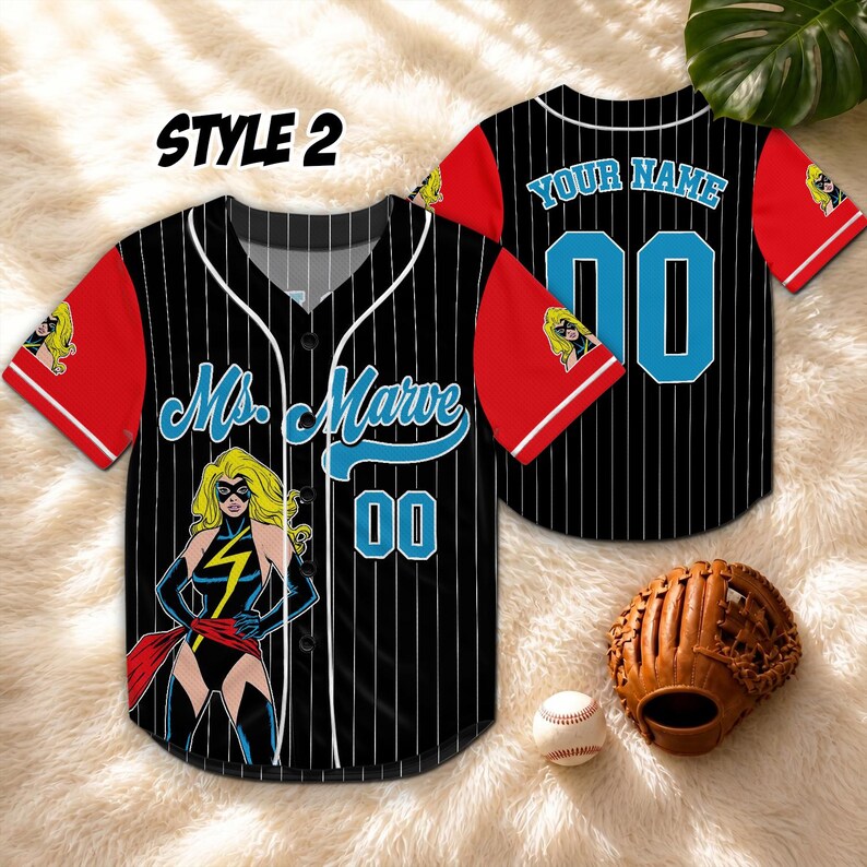 May include: Black and white pinstripe baseball jersey with red sleeves. Features the text "Ms. Marvel" and the number "00" in blue. Includes a cartoon graphic of Ms. Marvel. A baseball glove and ball are also visible.