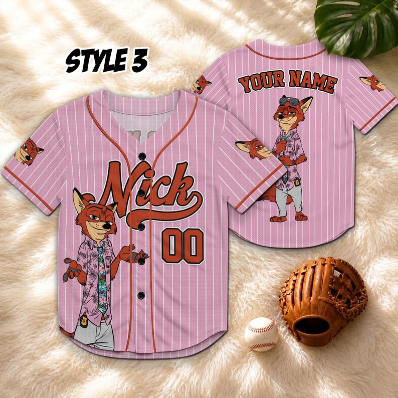 May include: Pink baseball jersey with vertical white stripes, featuring the name "Nick" and the number "00" in brown. The jersey has a cartoon fox character on the front and back. A baseball glove and ball are also in the image.