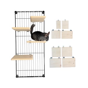 May include: A black wire grid wall panel featuring four light-colored wooden platforms attached to it, with a grey chinchilla standing on one shelf. To the right, there are seven additional wooden platforms of varying sizes with metal hardware.