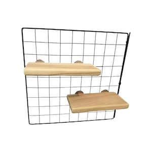 May include: A black metal wire grid wall panel featuring two rectangular light-colored wooden shelves attached to the grid. The shelves are positioned at different heights, with one on the left and one on the right, creating a tiered display arrangement.
