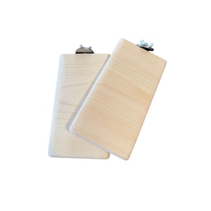 May include: Two rectangular light-colored wooden platforms with smooth surfaces and rounded edges. Each piece features a metal bolt and a wing nut attached to the top edge, designed for secure mounting. The wood grain is visible and light in tone.