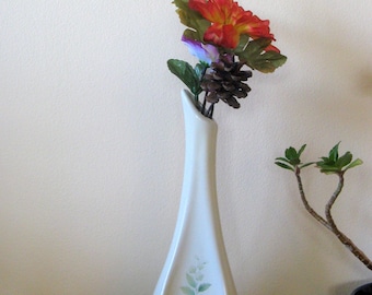 Vintage vase with artificial flowers on barbed wire stems