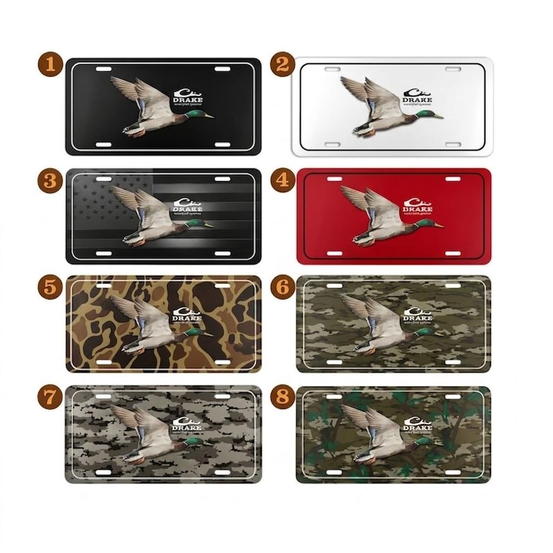 May include: A collection of eight license plates featuring a flying duck graphic. The plates have various backgrounds, including black, white, red, camouflage, and an American flag design. Each plate includes the "DRAKE" logo.