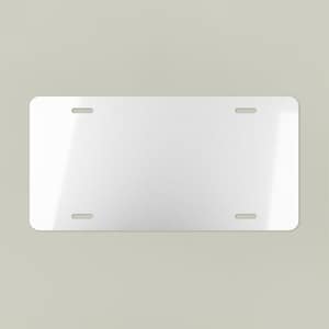 May include: A blank, rectangular license plate with rounded corners. The plate is white with four evenly spaced mounting holes. The surface has a slight sheen, reflecting ambient light.