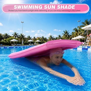 May include: A pink inflatable swimming sun shade floating on blue pool water. The text SWIMMING SUN SHADE and Protect you from harsh sunlight while swimming, so you can enjoy swimming to the fullest is displayed at the top of the image.