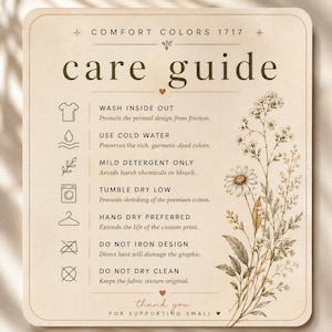 May include: A beige care guide for Comfort Colors 1717 garments featuring dark brown text and icons. Instructions include wash inside out, use cold water, mild detergent, tumble dry low, hang dry, do not iron, and do not dry clean with floral art.