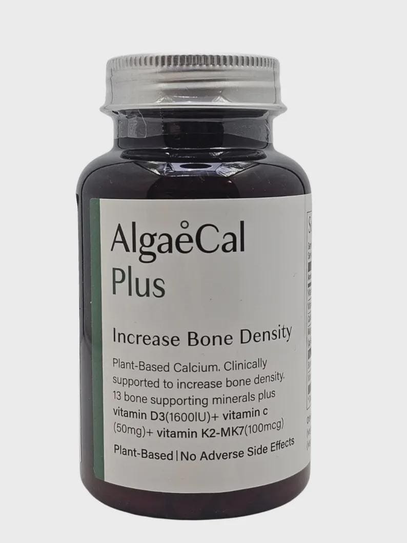 May include: A dark brown supplement bottle with a silver cap and a white label. The label reads "AlgaeCal Plus" and "Increase Bone Density." It lists ingredients including vitamin D3 and vitamin C. The bottle is plant-based and has no adverse side effects.