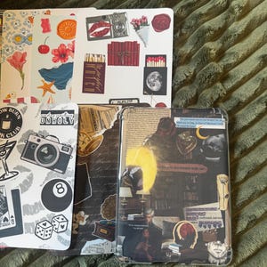 May include: A collection of decorative stickers and a phone case with a collage design. The stickers feature various illustrations, including a camera, lips, flowers, and an 8-ball. The phone case has a layered design with a vintage aesthetic.