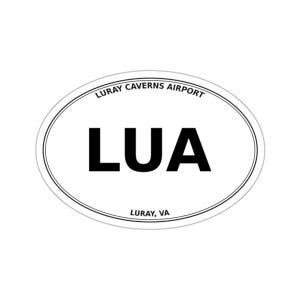 May include: An oval-shaped white sticker featuring the bold black text LUA in the center. The top arc displays the text LURAY CAVERNS AIRPORT, while the bottom arc displays the text LURAY, VA. The design is enclosed by a thin black double-line border.