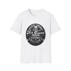 May include: A white t-shirt featuring a black and white graphic. The graphic is a circular design with the words "Tech Support Genius" and the phrase "Have you tried turning it off & on again?" The shirt is a crew neck.