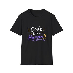 May include: Black t-shirt with the text "Code Like a Human!!" in white, purple, and yellow. The design includes a heart symbol. The shirt is a crew neck and has short sleeves.
