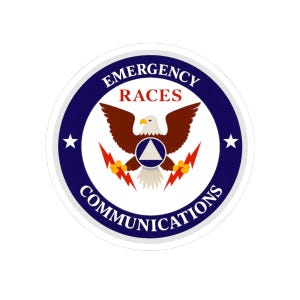May include: A circular sticker featuring a dark blue border with the white text EMERGENCY COMMUNICATIONS. In the center, a brown eagle with a white head holds two red lightning bolts. A blue circle with a white triangle sits on the eagle.