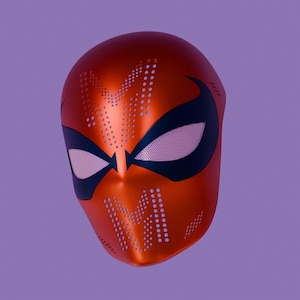 May include: A metallic red full-face mask featuring large, dark blue eye cutouts with light-colored mesh lenses. The surface is adorned with perforated patterns, including two prominent letter M shapes on the forehead and chin areas.