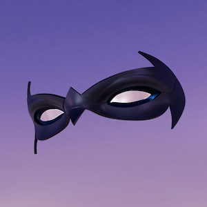 May include: A black superhero mask with a sleek, aerodynamic design. The mask features pointed edges and eye openings with a textured, reflective surface. The background is a gradient of purple and blue.