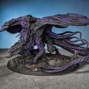 May include: A detailed figurine of a dragon with a dark grey and purple color scheme. The dragon has large, textured wings and is posed on a rocky base. The dragon's scales and features are intricately sculpted, showcasing a fantasy theme.