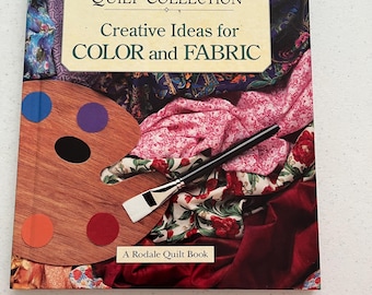 May include: A book titled "The Classic American Quilt Collection: Creative Ideas for Color and Fabric" with a colorful fabric background and a paint palette with paintbrushes.